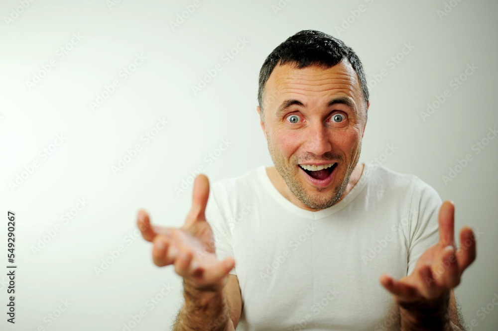 adult unshaven handsome man with beard wearing casual sweater and glasses over blue background very happy and excited doing winner gesture with arms raised, smiling and screaming for success adult unshaven handsome man with beard wearing casual sweater and glasses over blue background very happy and excited doing winner gesture with arms raised, smiling and screaming for success