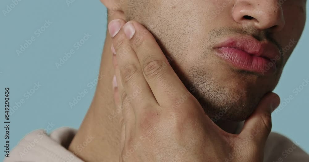 Closeup of man applying cream on beard zone. Handsome guy putting moisturizer Closeup of man applying cream on beard zone. Handsome guy putting moisturizer