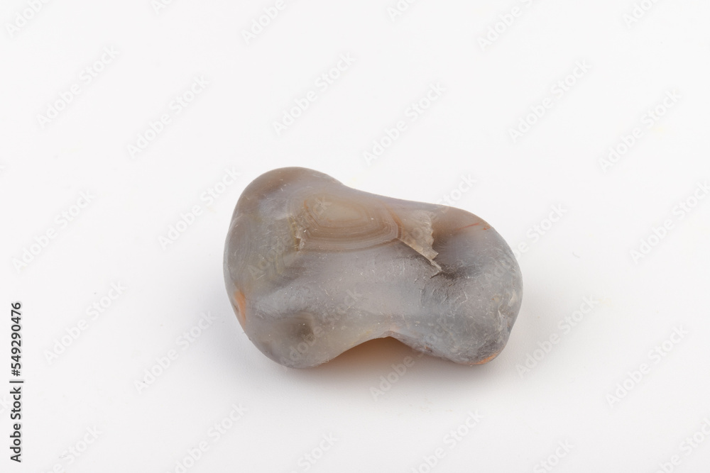 Fototapeta premium Multicolored gemstones, tumbled minerals. Bostwan agate of various sizes on a white background.