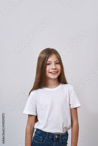 Cute smiling caucasian little girl look at camera