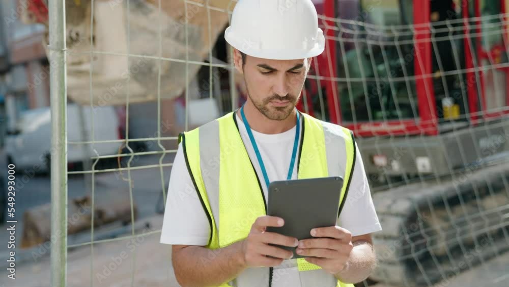 Young hispanic man architect using touchpad at street Young hispanic man architect using touchpad at street
