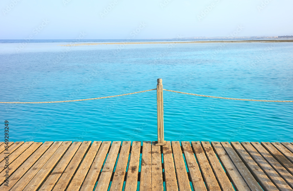 Fototapeta premium Wooden pier with rope railing, selective focus.
