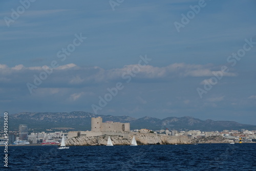 Sailboats circle Chateau D'if in Marseille France