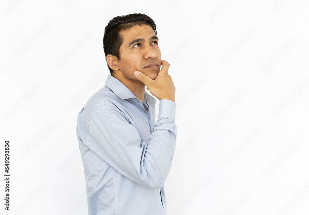 Pensive man touching his chin and thinking. Side view of serious Indian man looking up, trying to solve problem, considering ideas. Contemplation, planning, concentration concept Pensive man touching his chin and thinking. Side view of serious Indian man looking up, trying to solve problem, considering ideas. Contemplation, planning, concentration concept