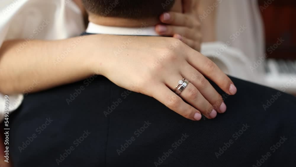 the bride hugs her husband at the wedding
