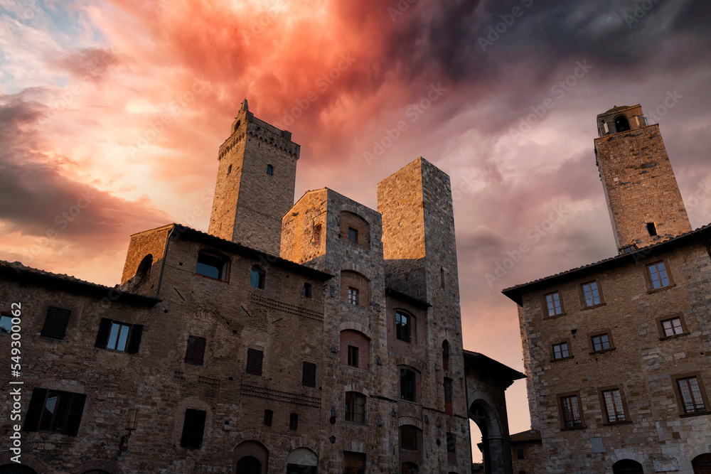 view at sunset of the towers of the town of san gimignano in tuscany
