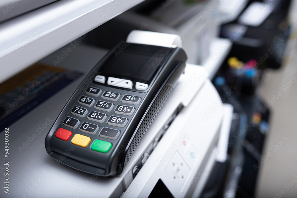 Bank terminal and payment card in the office interior.