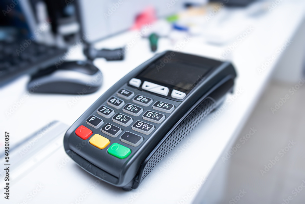 Bank terminal and payment card in the office interior. Bank terminal and payment card in the office interior.