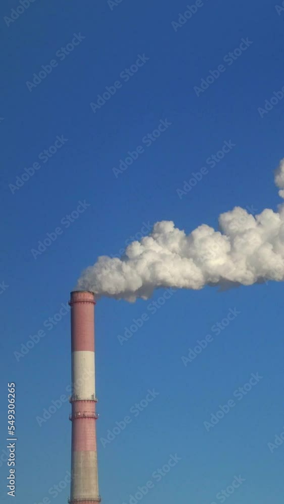 Time lapse of one pipe and smoke against blue sky Time lapse of one pipe and smoke against blue sky
