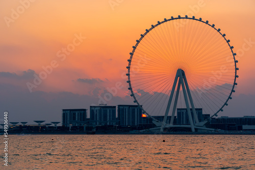 Amazing sunset colors over the sea view to the Ain Dubai, giant Ferris at Bluewaters Island  close to JBR beach. Dubai Eye fits perfect to modern UAE skyline.