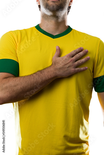 фотографія Brazilian soccer player, listening to the national anthem with his hand on his chest