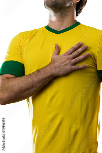 Brazilian soccer player, listening to the national anthem with his hand on his chest