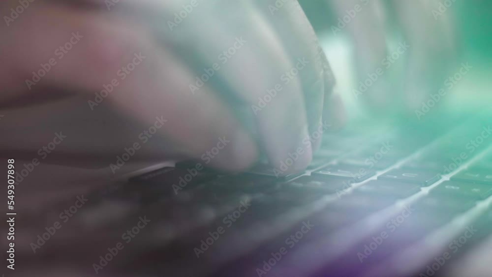Close-up of a programmer hands typing on a computer keyboard. Beautiful glow of glare on the freelancer keyboard Close-up of a programmer hands typing on a computer keyboard. Beautiful glow of glare on the freelancer keyboard