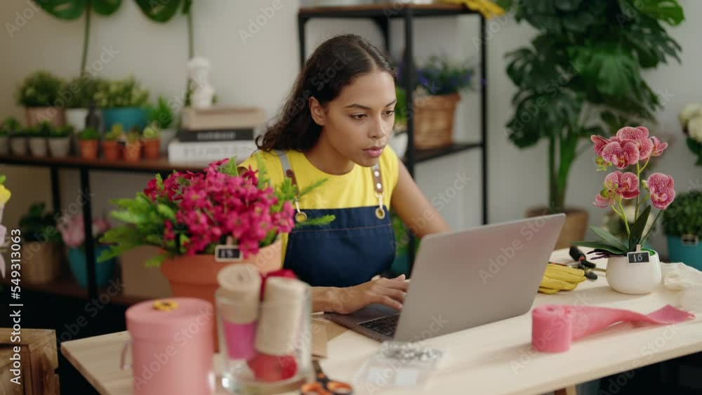 Young african american woman florist smiling confident using laptop at flower shop Young african american woman florist smiling confident using laptop at flower shop