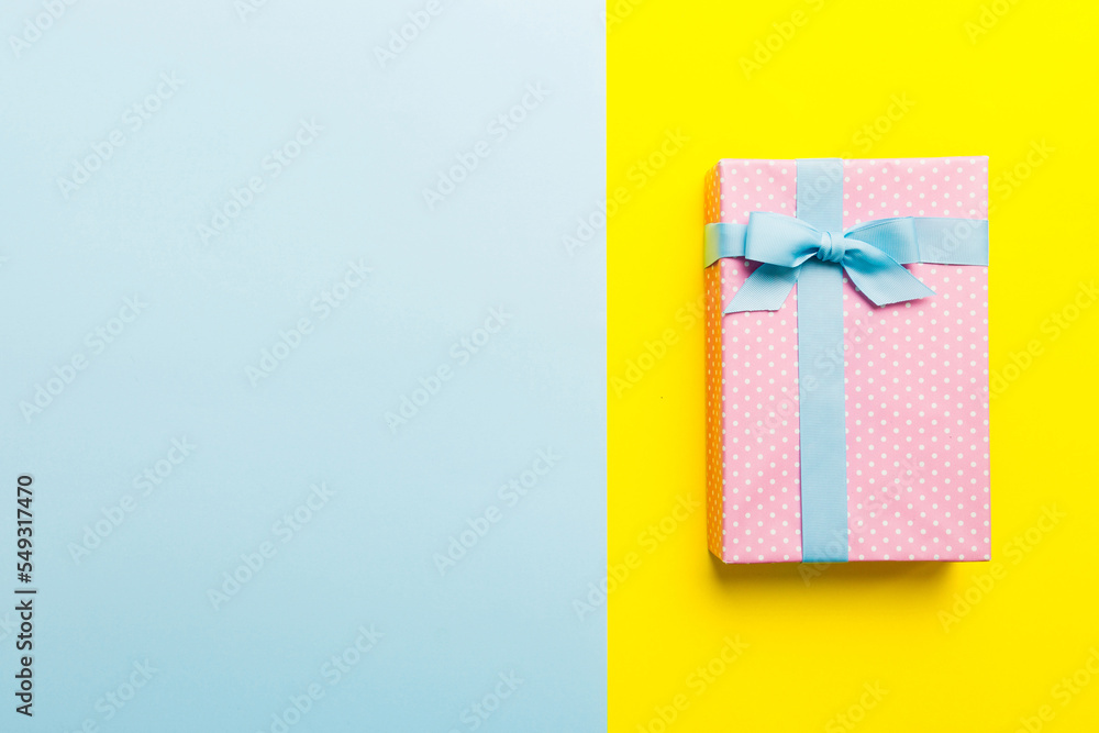 holiday handmade paper present tied blue ribbon bow top view with copy space. Flat lay holiday background. Birthday or christmas present. Christmas gift box concept with copy space holiday handmade paper present tied blue ribbon bow top view with copy space. Flat lay holiday background. Birthday or christmas present. Christmas gift box concept with copy space