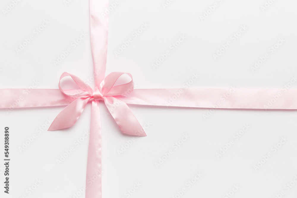 Top view of purple ribbon rolled and pink bow isolated on colored background. Flat lay with copy space Top view of purple ribbon rolled and pink bow isolated on colored background. Flat lay with copy space