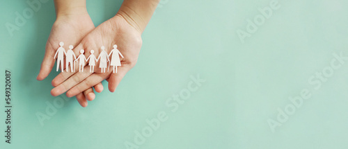 Foto Hands holding multi generation family paper, family wellness, health insurance c