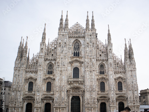 Artistic and picturesque photo of a detail of the Milan Cathedral (Metropolitan Cathedral of the Nativity of the Blessed Virgin Mary) symbol of the Lombard capital surrounded by a sky full of clouds .