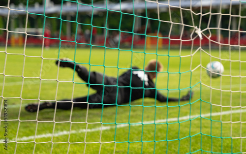 Goalkeeper saves shot football soccer goal net