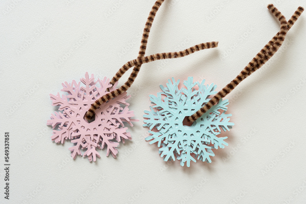 collection of paper snowflakes strung on pipe cleaners collection of paper snowflakes strung on pipe cleaners