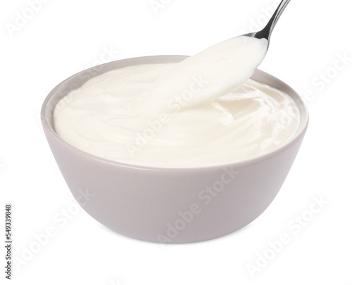 Ceramic bowl and spoon with delicious organic yogurt on white background