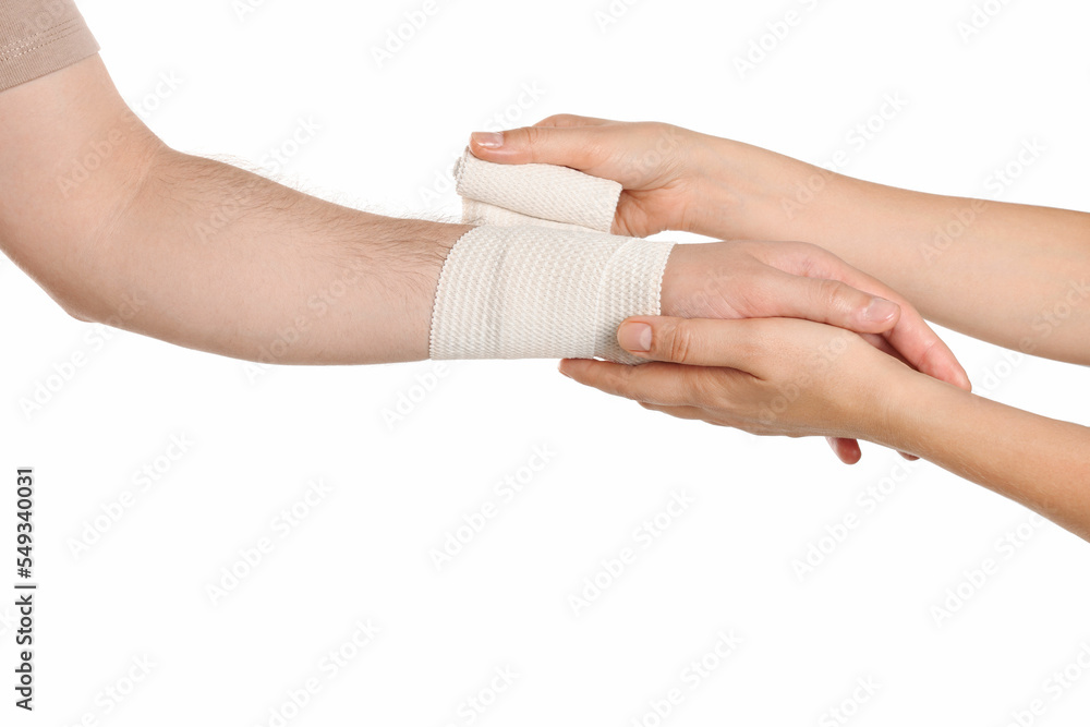 Doctor applying medical bandage onto patient's hand on white background, closeup Doctor applying medical bandage onto patient's hand on white background, closeup