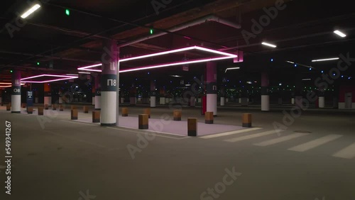 View from drone of the underground parking shopping mall with LED pink lamp in night summer day