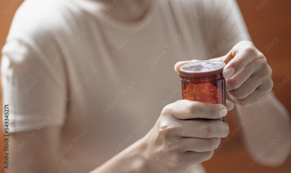 Close up of a person holding a pill bottle Close up of a person holding a pill bottle