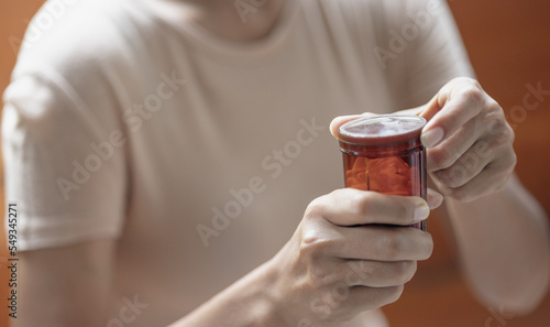 Close up of a person holding a pill bottle