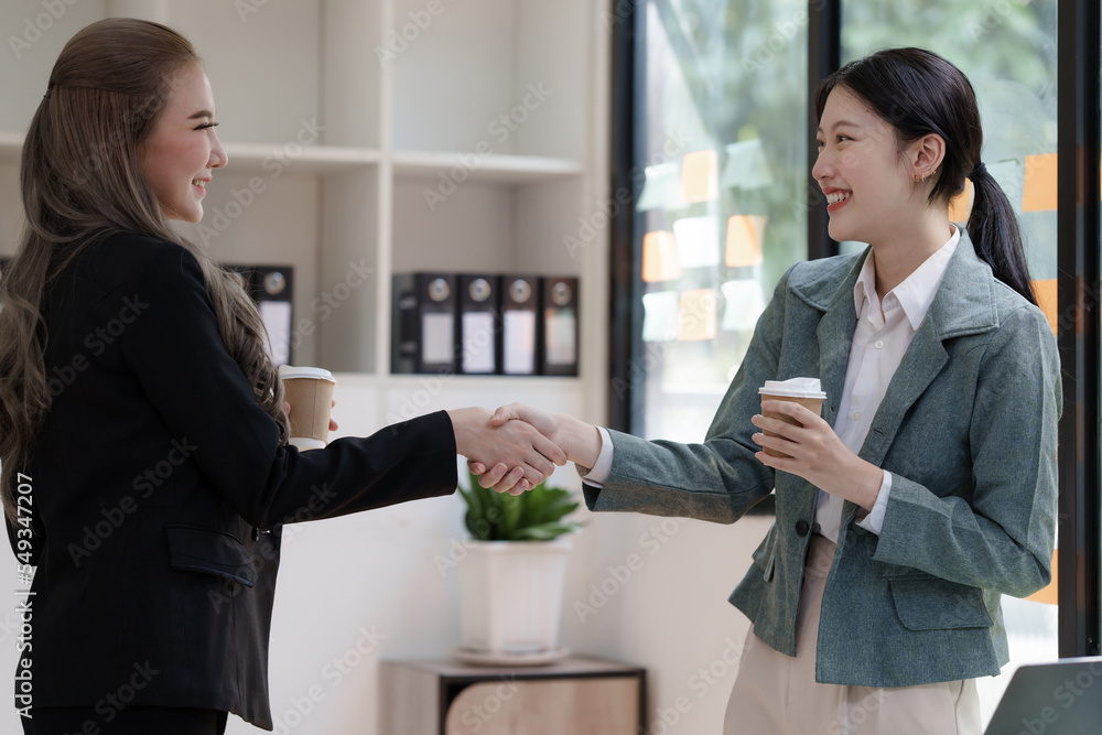 Female business worker with colleagues in Thailand working together at office desk, getting shaking hands, successful and agreement concept Female business worker with colleagues in Thailand working together at office desk, getting shaking hands, successful and agreement concept