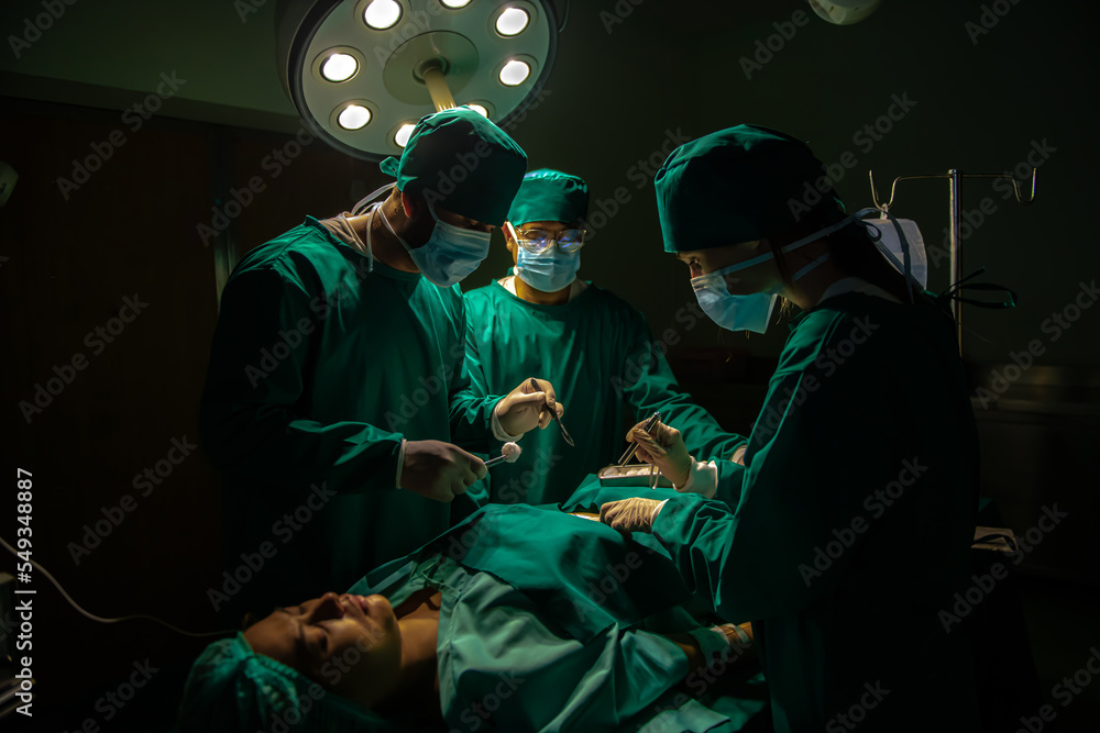 Group of surgeons doing surgery in hospital operating theater. Medical team doing critical operation. Group of surgeons doing surgery in hospital operating theater. Medical team doing critical operation.