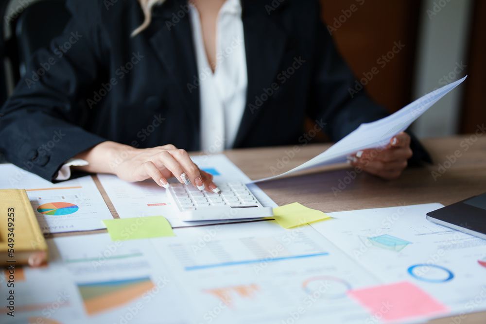 Accountants, Asian auditors are using calculators and computers to review annual tax budgets to submit information to the IRS. Accountants, Asian auditors are using calculators and computers to review annual tax budgets to submit information to the IRS.