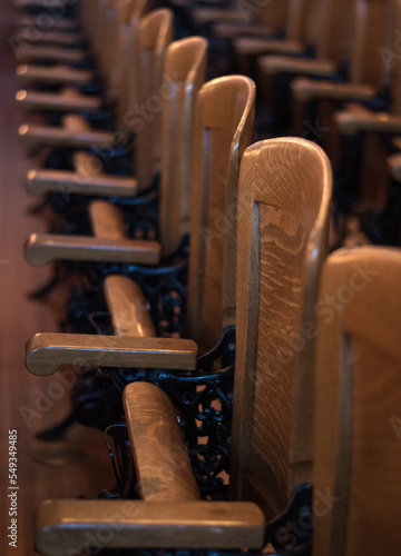 Old vintage wooden folding chairs inside a historic courtroom