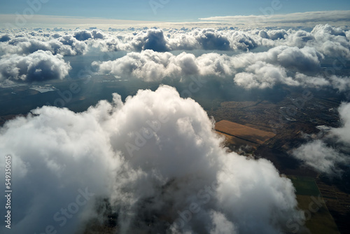 Photography Aerial view at high altitude of earth covered with puffy cumulus clouds forming