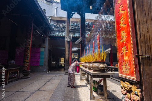 HO CHI MINH CITY, Vietnam - November 08, 2022 - Chua Ba Thien Hau Pagoda in Saigon. Inside Thien Hau Temple, Chinese-style temple of the Chinese sea goddess Mazu. People with burning incense praying.