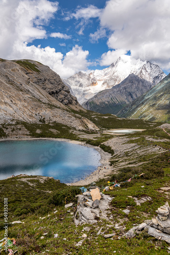 Vertical image of blue sky, copy space for text of the Five Colors Lake at Doacheng Yading National park, Sichuan, China. Last Shangri-la, Tibetan Sichuan