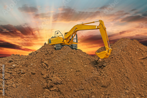 Crawler Excavators are digging the soil in the construction site on the sunbeam sky backgrounds.