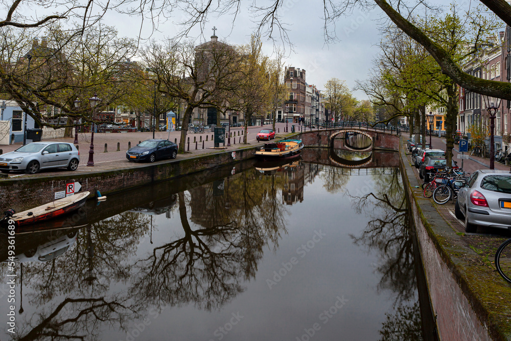 Amsterdam canals and typical houses with a morning spring sky.