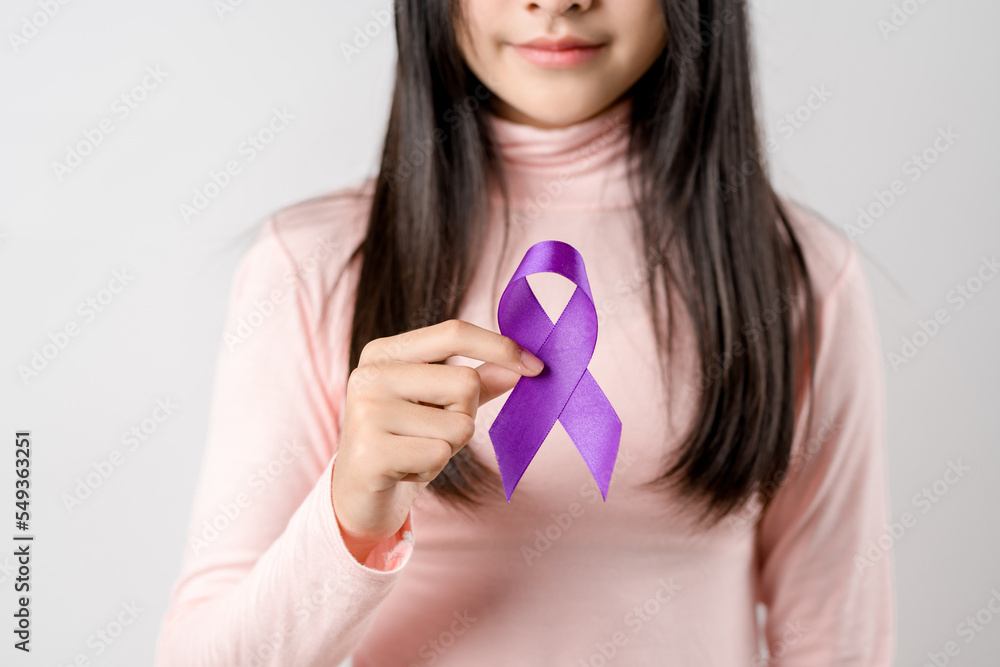 woman hands holding purple ribbon, Alzheimer disease, Pancreatic cancer, Epilepsy awareness, world cancer day on a purple colored background, World Cancer Day concept woman hands holding purple ribbon, Alzheimer disease, Pancreatic cancer, Epilepsy awareness, world cancer day on a purple colored background, World Cancer Day concept