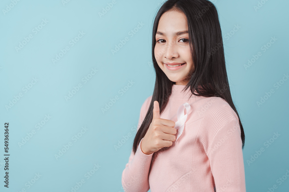 happy woman showing pink ribbon, Breast cancer awareness, world cancer day, national cancer survivor day in february concept... happy woman showing pink ribbon, Breast cancer awareness, world cancer day, national cancer survivor day in february concept...
