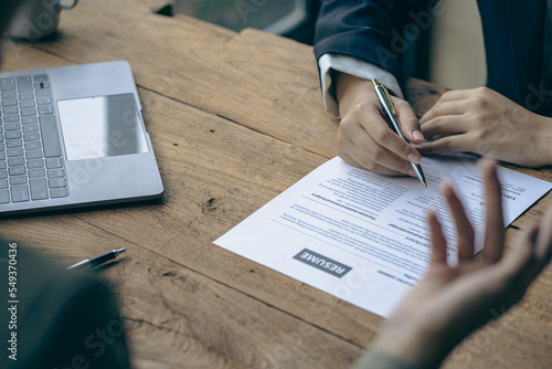 Hiring concept HR manager is interviewing a job candidate filling out a resume on a job application form to be considered for a job