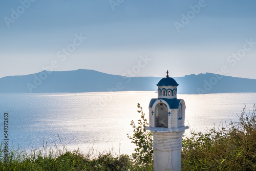 Small white and blue tower with the sea in the background