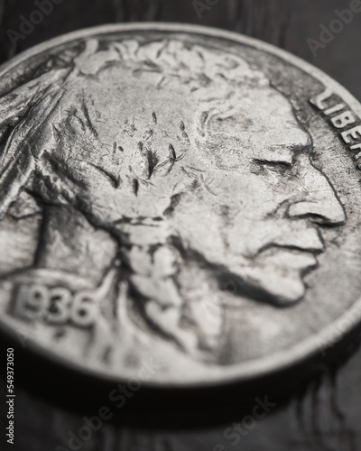 US nickel lies on a dark table surface. Coin 5 five cents close up. Indian Head nickel. News about USA economy. American money. Public debt and treasury. Five-cent coin. Vertical stories. Macro