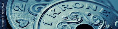 Danish coins. 1 Danish krone coin closeup. National currency of Denmark. Blue and green money banner or header for news about economy or finance. Loan and credit. Tax and inflation. Macro