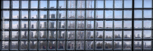 Background texture of glass block window with outline of city skyscrapers in panorama format