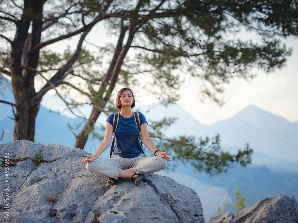 woman traveler walking by Lycian Way trail mountains in Turkey near Antalya. Woman meditating yoga alone in sunrise mountains. concept of spiritual relaxation for travel. Harmony with nature.