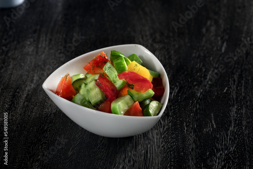 close up view of fresh vegetable salad on grey background