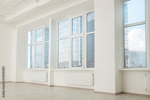 Modern office room with white walls and windows. Interior design