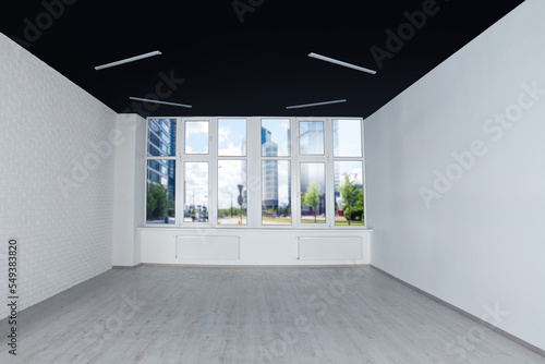 Empty office room with black ceiling and clean windows. Interior design