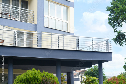 Exterior of beautiful building with balconies against blue sky